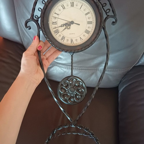 Vintage table clock with pendulum from wrought iron decorative