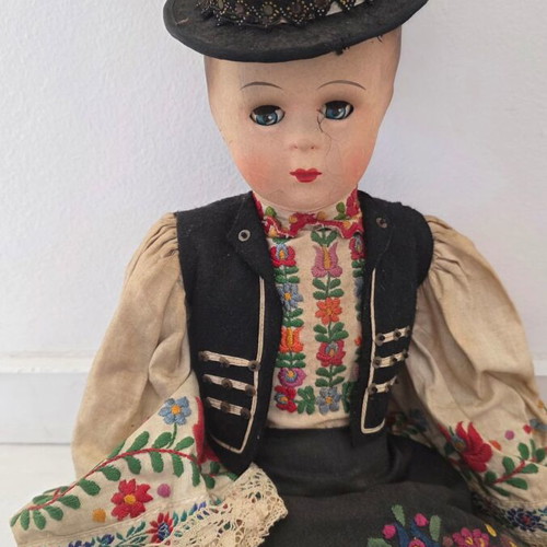 Traditional doll used with embroidered costume and hat