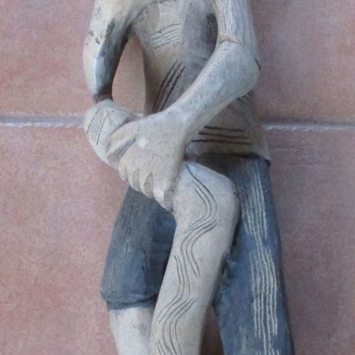 Wooden carved figure used from Colombia with traditional Pan flute