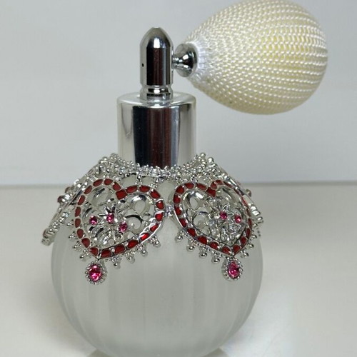 Vintage perfume bottle with pump, decorative hearts and crystals