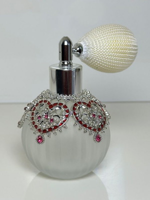 Vintage perfume bottle with pump, decorative hearts and crystals