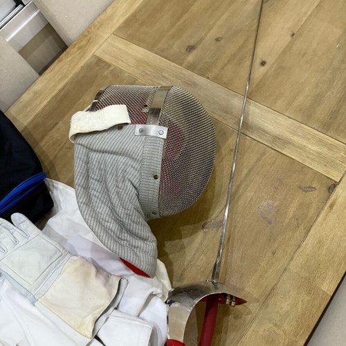 Fencing accessories used, helmet, sword, vest and bag