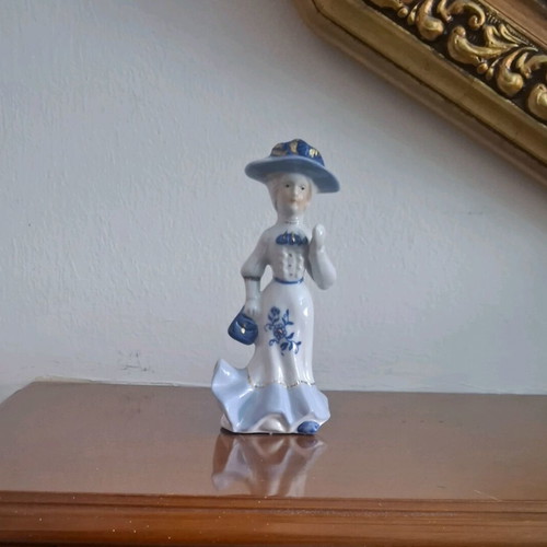 Retro porcelain woman figurine with gold details like new