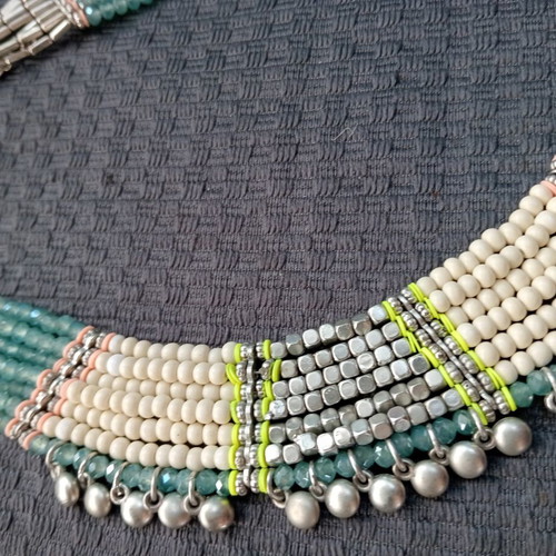 Accessorize multistrand necklace with plastic and glass beads