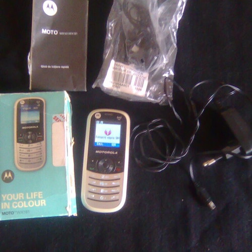 Motorola WX181 like new mobile phone with charger, headphones, and box