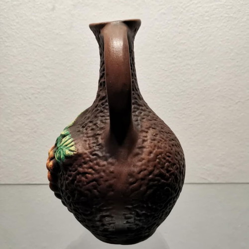 Clay jug used with embossed designs and grape cluster