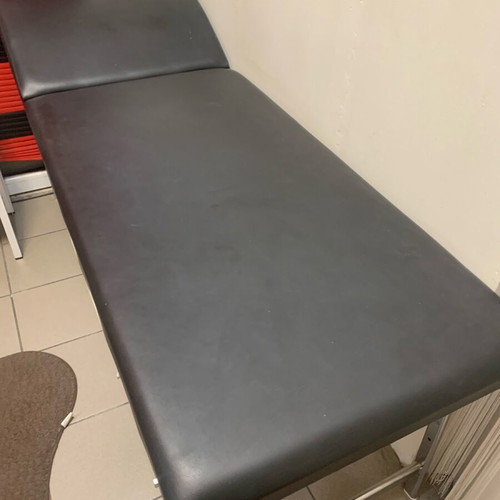 Examination bed used, black with inox folding legs