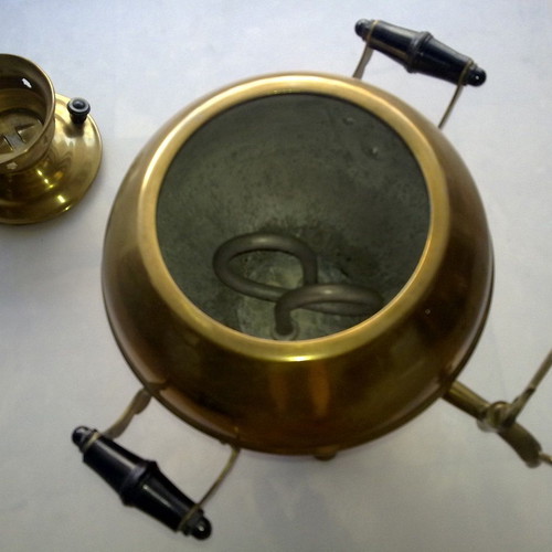 Bronze teapot with spout and heating element used