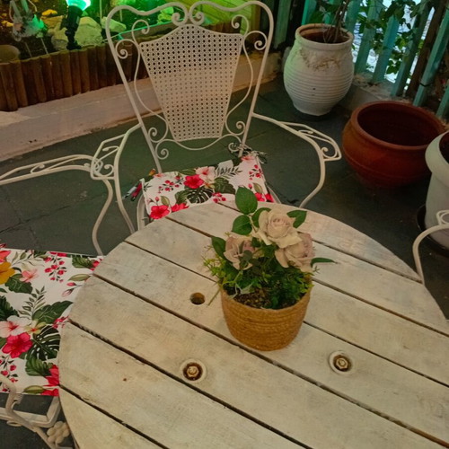 Wrought iron chairs set with round wooden table, vintage