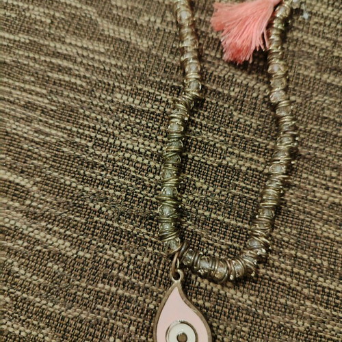 Long necklace used with pink evil eye and tassel
