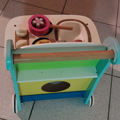 Wooden play kitchen with oven used, with pots and spoons
