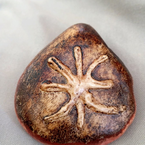 Handmade pebble with Delphic E, paperweight like new