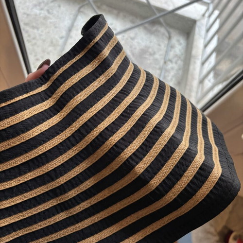 Steve Madden bucket hat with striped design and adjustable opening for ponytail