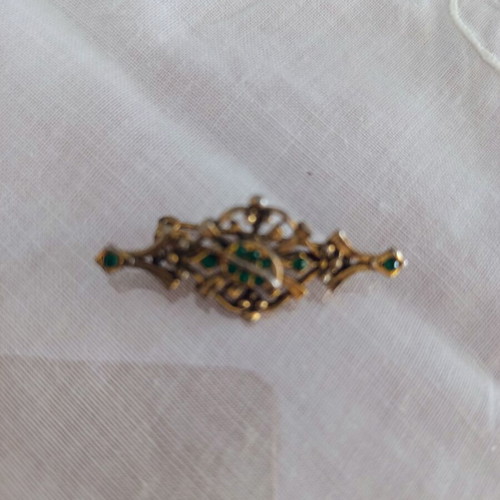 Vintage rhombus brooch with green stones used