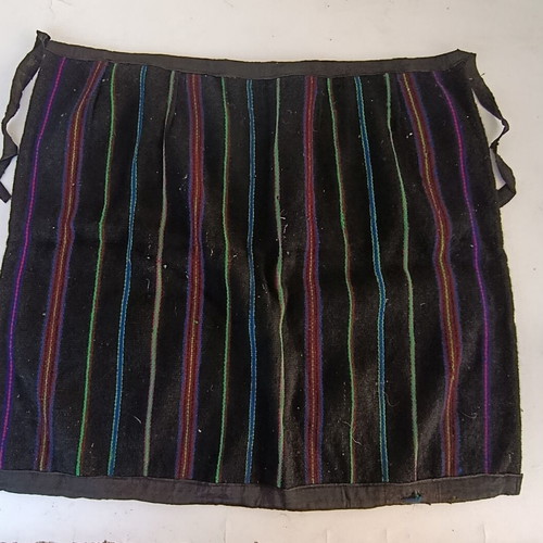 Traditional apron with colorful vertical stripes, used