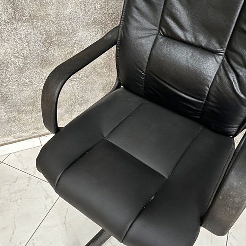 Black executive office chair with armrests and wheels