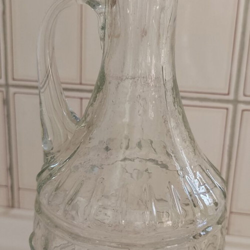 Glass decanter used with handle and beautiful pattern, unusual design