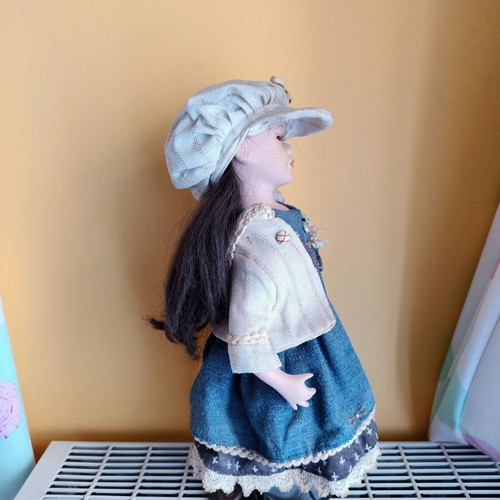 Porcelain doll with stand, 42 cm