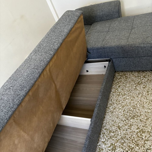 Corner sofa bed with storage compartments