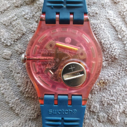 Swatch unicex watch used with transparent case and pink plastic strap