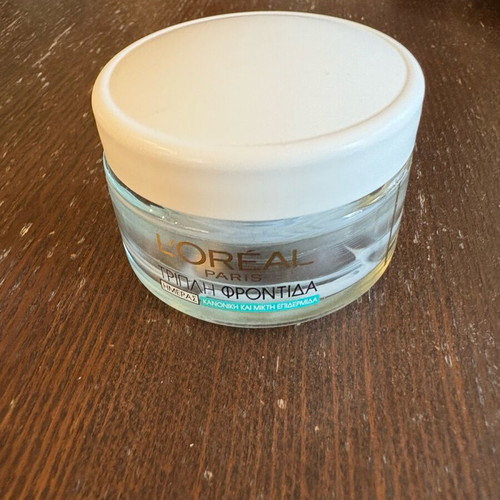 L’Oréal day cream bottle used, empty