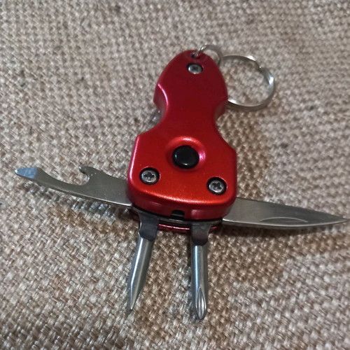 Mini multitool keychain KTEO used with flashlight