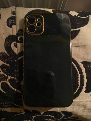 iPhone 11 case, black plastic with gold trim