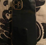 iPhone 11 case, black plastic with gold trim