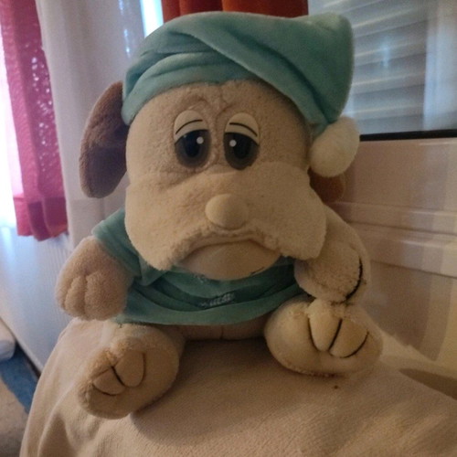 Stuffed animal dog in pajamas used with small seam opening