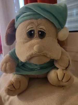 Stuffed animal dog in pajamas used with small seam opening