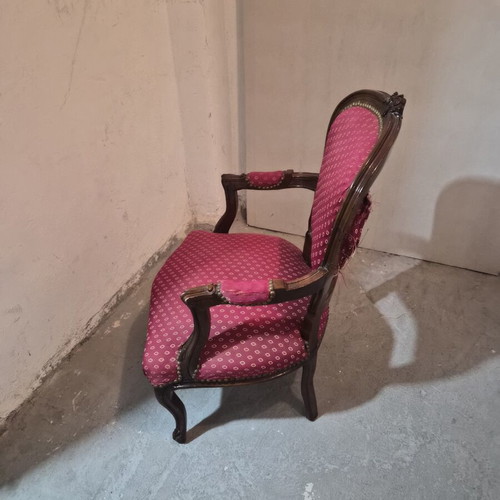 Armchair with carved wood frame and red fabric