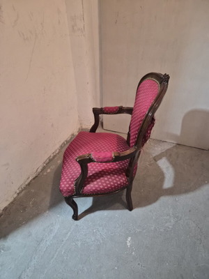 Armchair with carved wood frame and red fabric