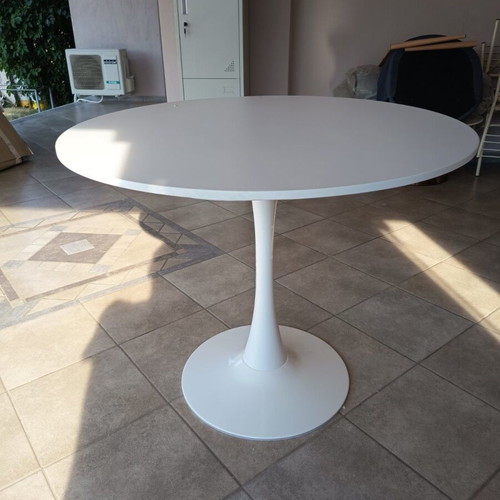 Round dining table with white MDF surface