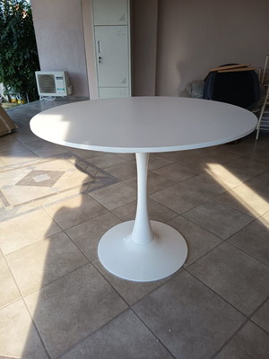 Round dining table with white MDF surface