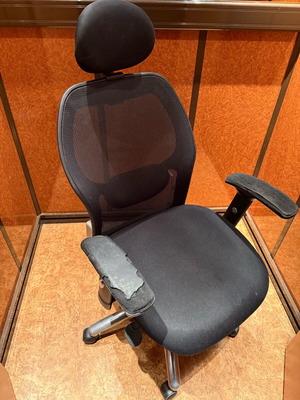 Ergonomic office chair with mesh used, worn armrests