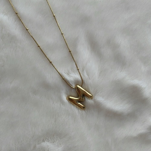 Monogram necklace new, gold color