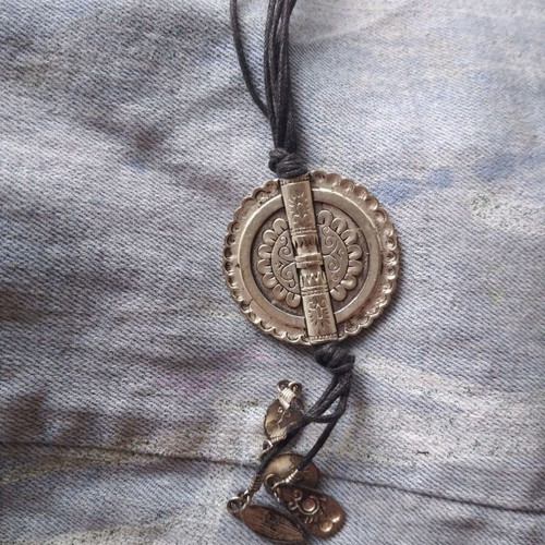 Necklace with steel pendant like new on leather straps
