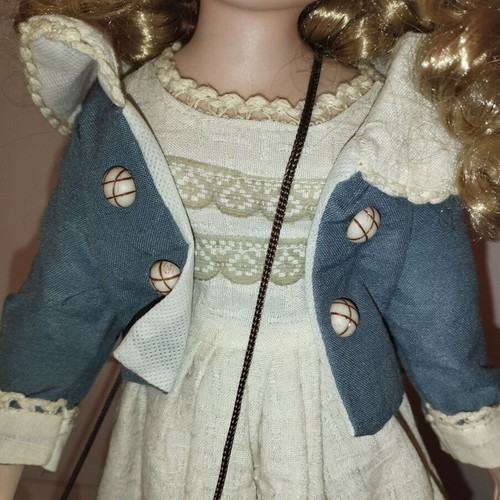 Porcelain doll rare, new with hat and dress