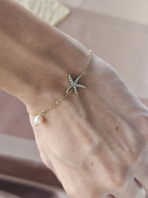 Steel bracelet with gold tone, blue star and pearl