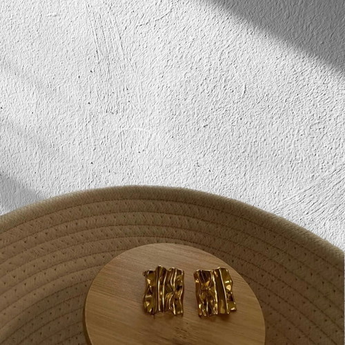 Earrings new in gold color with embossed design