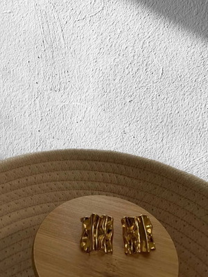 Earrings new in gold color with embossed design