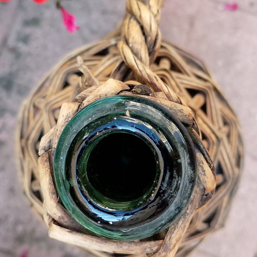 Vintage wicker wrapped demijohn with corncob stopper, used