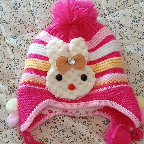 Knitted baby hat with pom pom and cute bunny design, like new