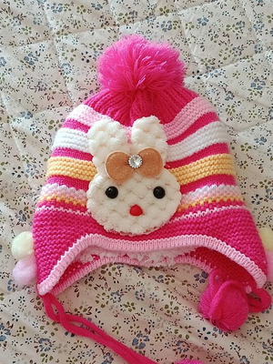 Knitted baby hat with pom pom and cute bunny design, like new