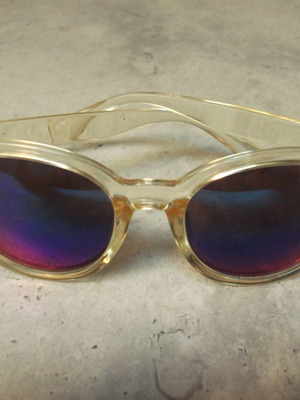 Sunglasses used with transparent frame and blue mirrored lenses