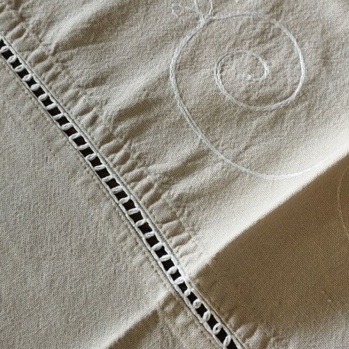 Linen tablecloth like new in earthy soft gray beige with embossed embroidery