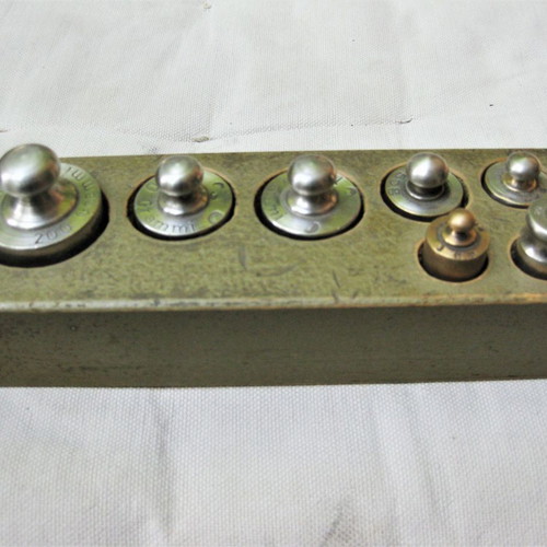 Set of old brass weights used with case