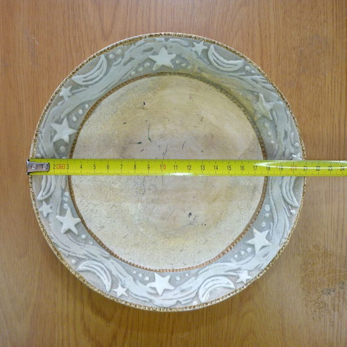 Decorative ceramic plate with embossed stars and moons like new