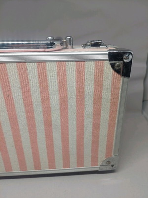 Retro cosmetic case used with pink-white stripes and metal details