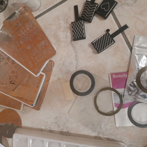 Nail art kit with tips, stamping plates and accessories